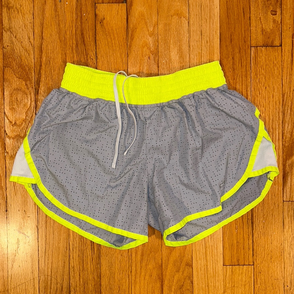 Nike gray athletic shorts with neon outline